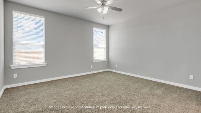 Secondary bedroom with soft carpet and bright windows.