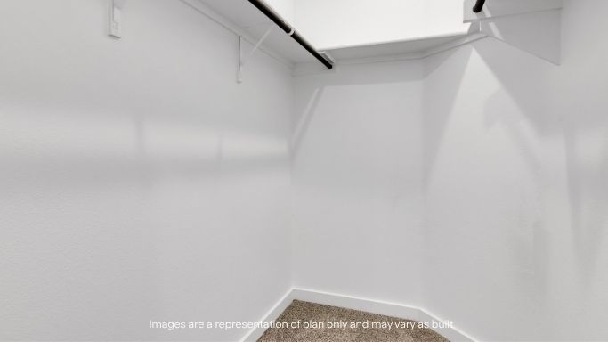 Spacious walk-in closet with built-in shelving.