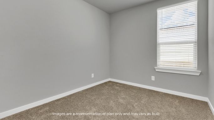 Secondary bedroom with natural lighting and closet access.
