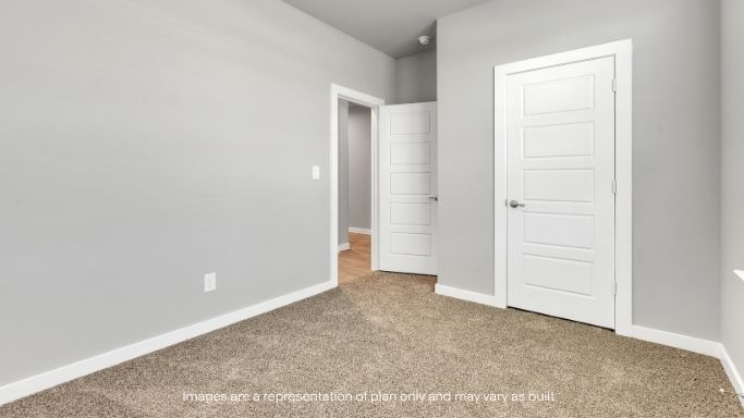 Additional bedroom with private feel and soft carpeting.