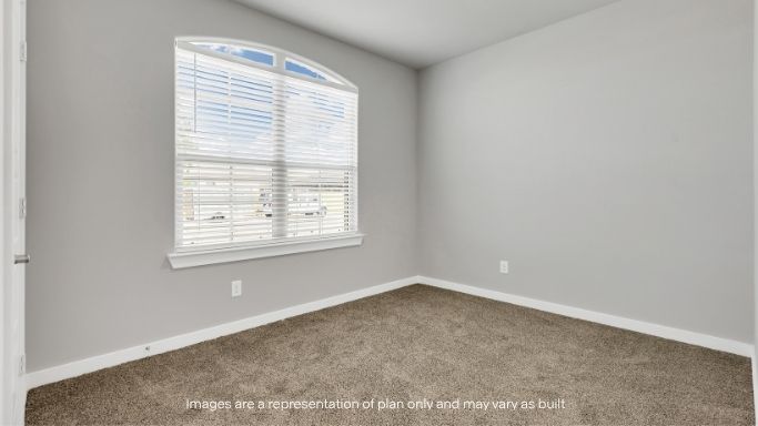 Bright bedroom featuring large front-facing windows.