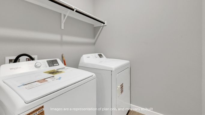 Laundry room with washer/dryer setup and storage shelf.