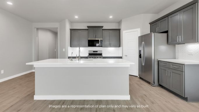 Open-concept kitchen featuring a spacious island and bright finishes.