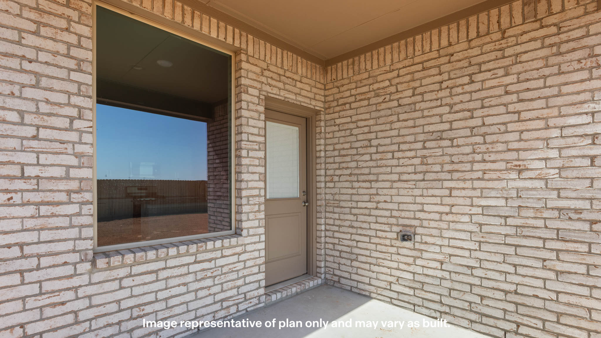 Covered back patio area overlooking spacious backyard