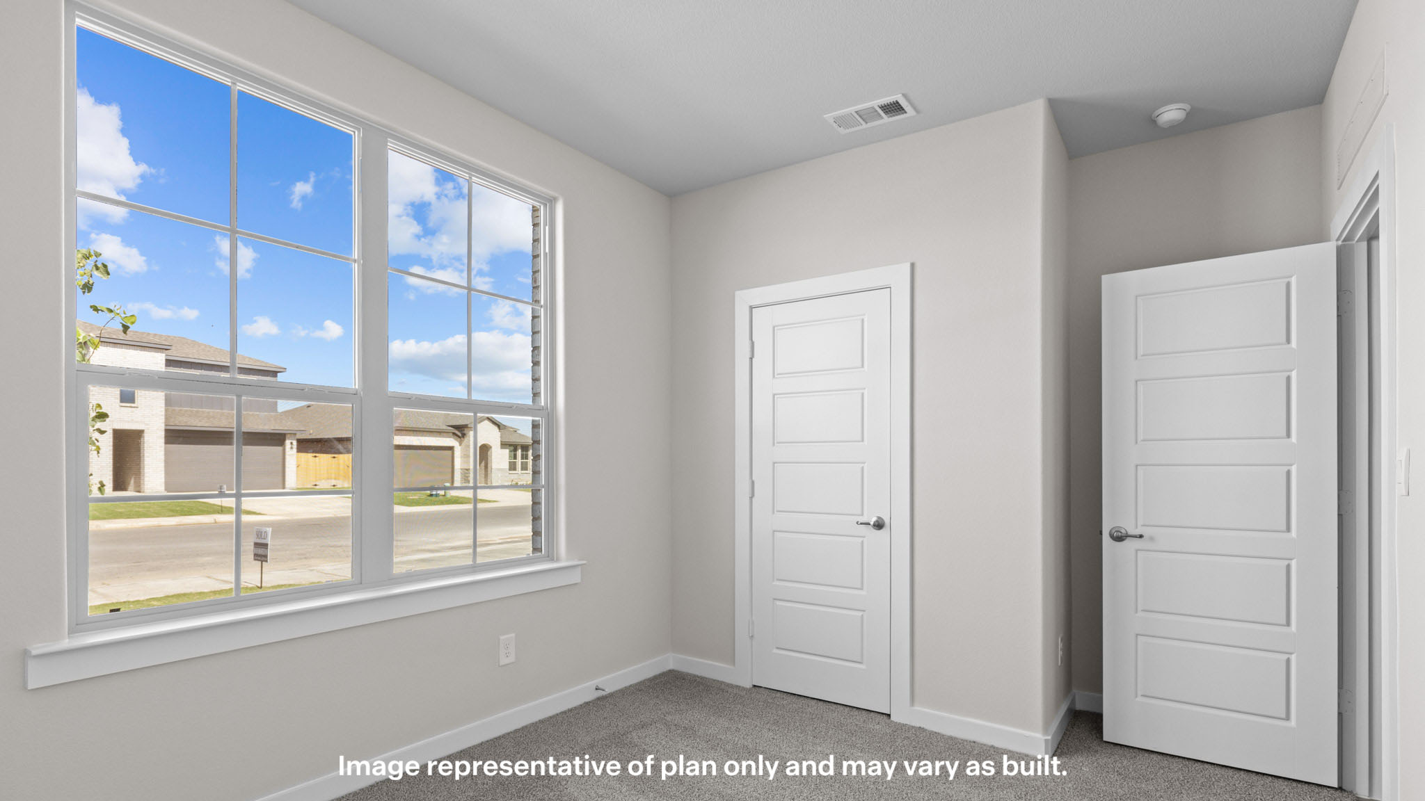 Guest bedroom 1 with front windows and ample natural light