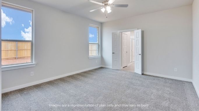 Primary bedroom with plush carpet floors and light allowing double windows