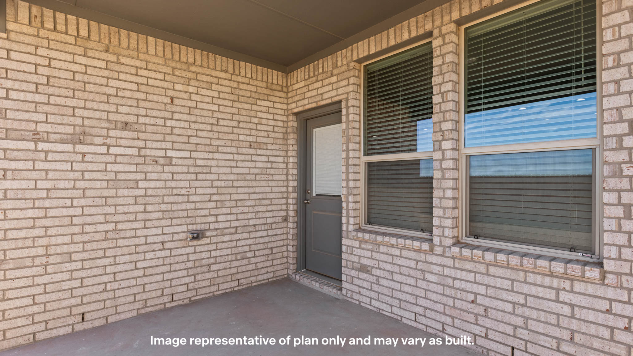 Covered back patio area overlooking spacious backyard