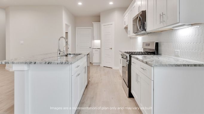 Open concept kitchen with stainless steel appliances, shaker style cabinets, and elevated finishes