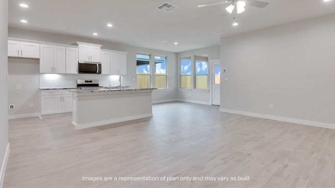 Open concept kitchen with stainless steel appliances, shaker style cabinets, and elevated finishes