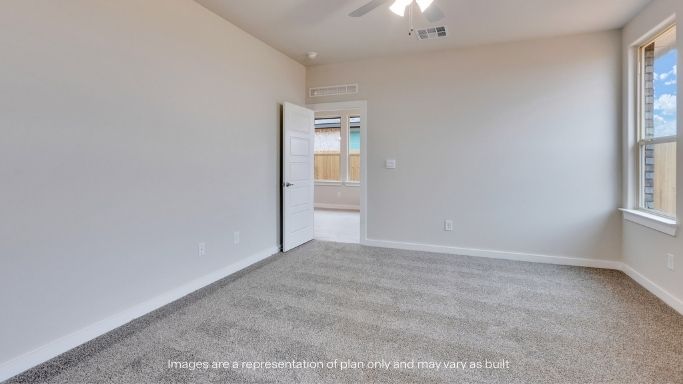 Primary bedroom with plush carpet floors and light allowing double windows