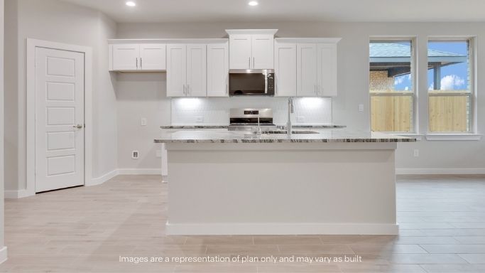 Spacious open concept kitchen with island and counter prep space