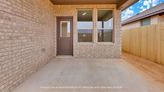 Covered back patio area overlooking spacious backyard
