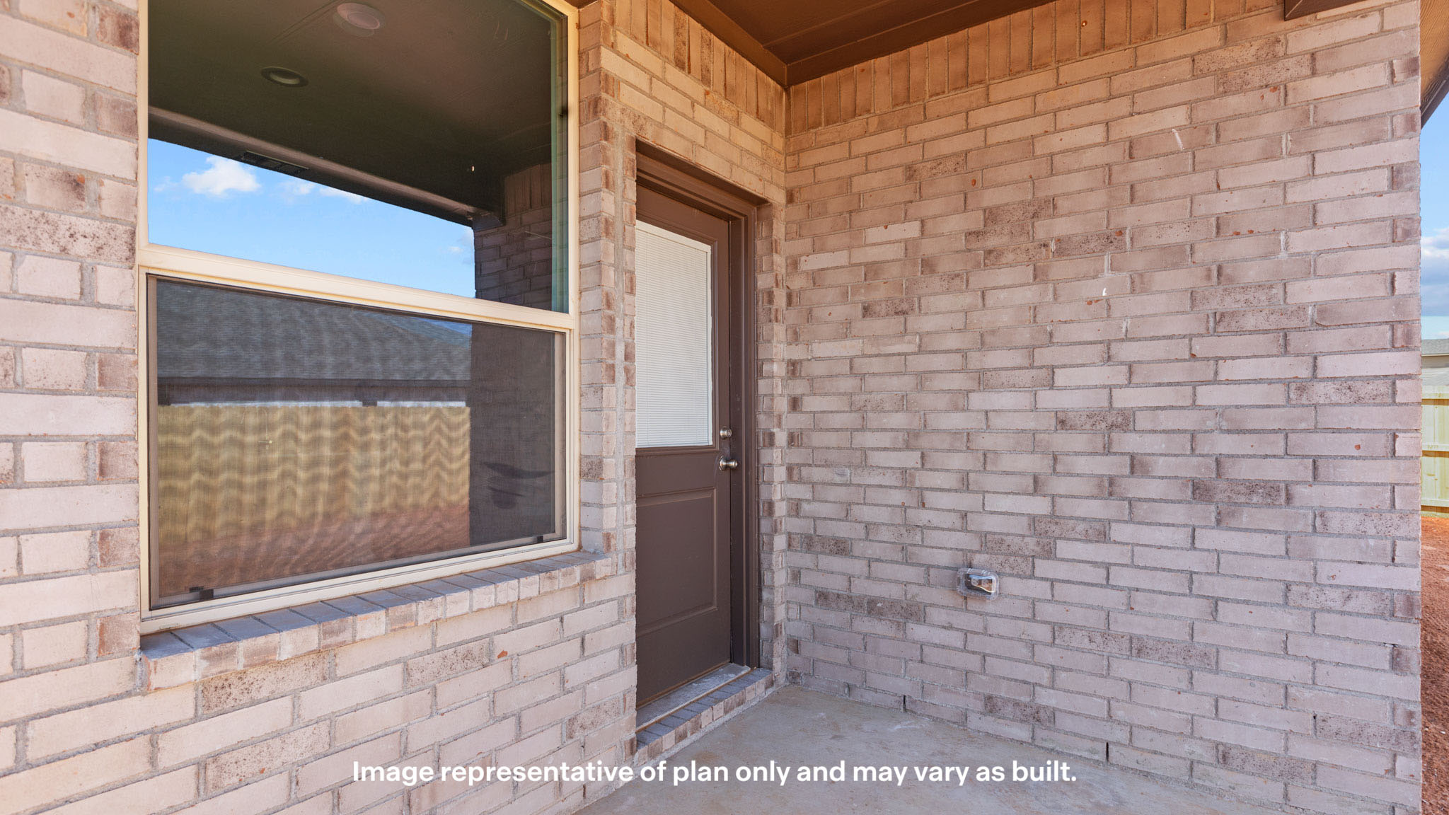 Covered back patio area overlooking spacious backyard