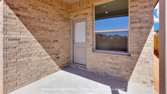 Covered back patio area overlooking spacious backyard