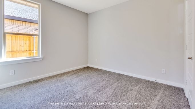 Guest bedroom 2 with side window and plush carpet floor