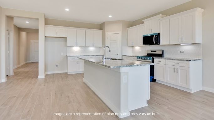 Spacious open concept kitchen with island and counter prep space