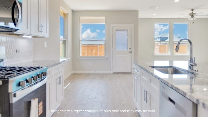 Open concept kitchen with stainless steel appliances, shaker style cabinets, and elevated finishes