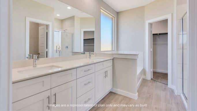 Private attached primary bathroom with built in vanity