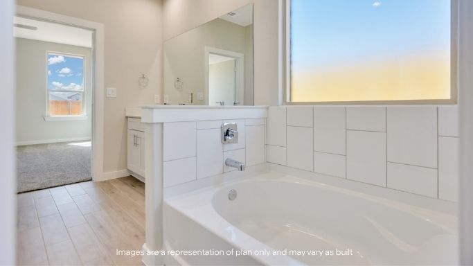 Private attached primary bathroom with built in vanity
