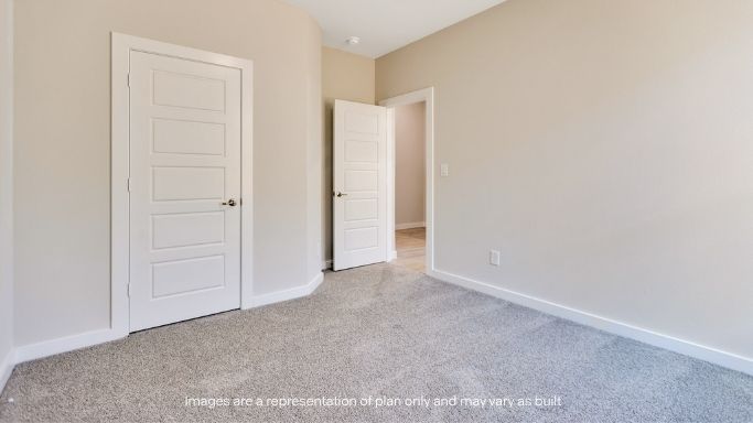 Guest bedroom 2 with side window and plush carpet floor