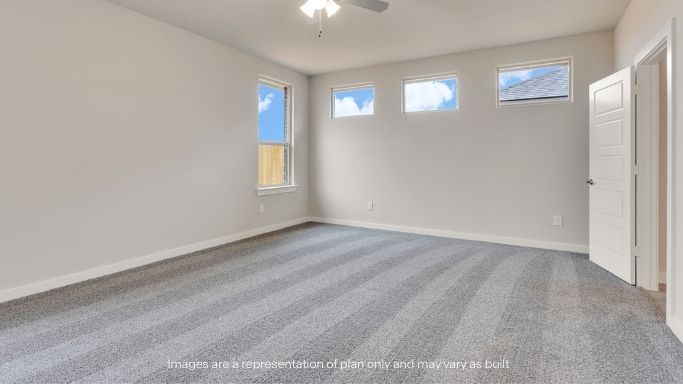 Primary bedroom with plush carpet floors and light allowing double windows