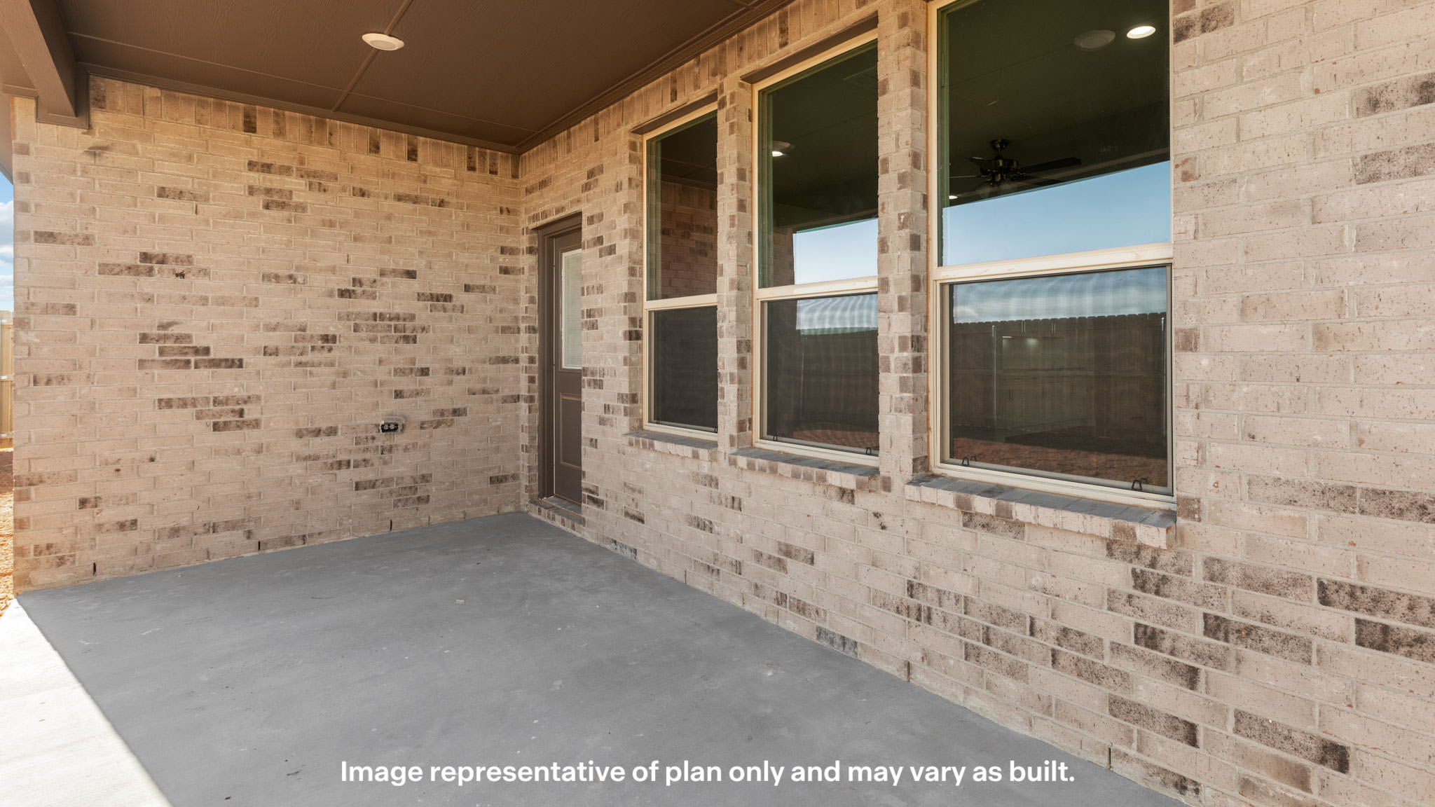 Covered back patio area overlooking spacious backyard