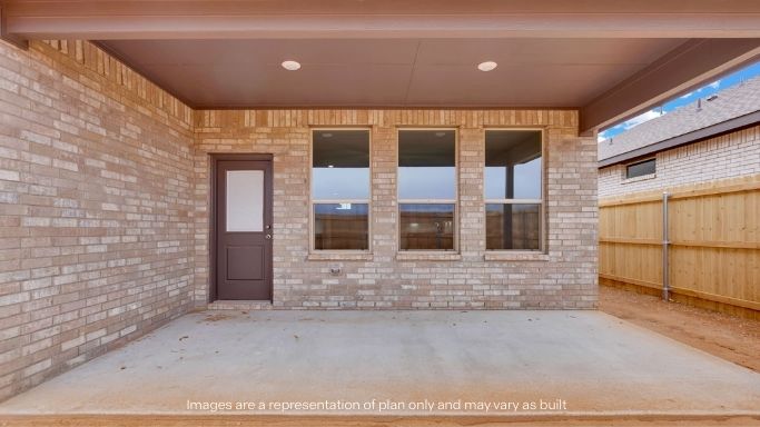 Covered back patio area overlooking spacious backyard