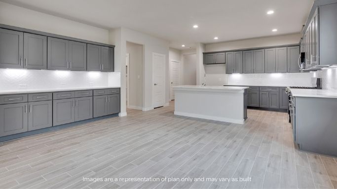 Open concept kitchen with stainless steel appliances, shaker style cabinets, and elevated finishes