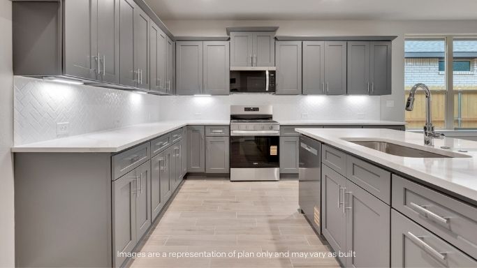 Open concept kitchen with stainless steel appliances, shaker style cabinets, and elevated finishes
