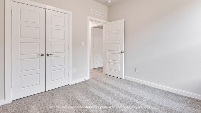 Guest bedroom 2 with side window and plush carpet floor