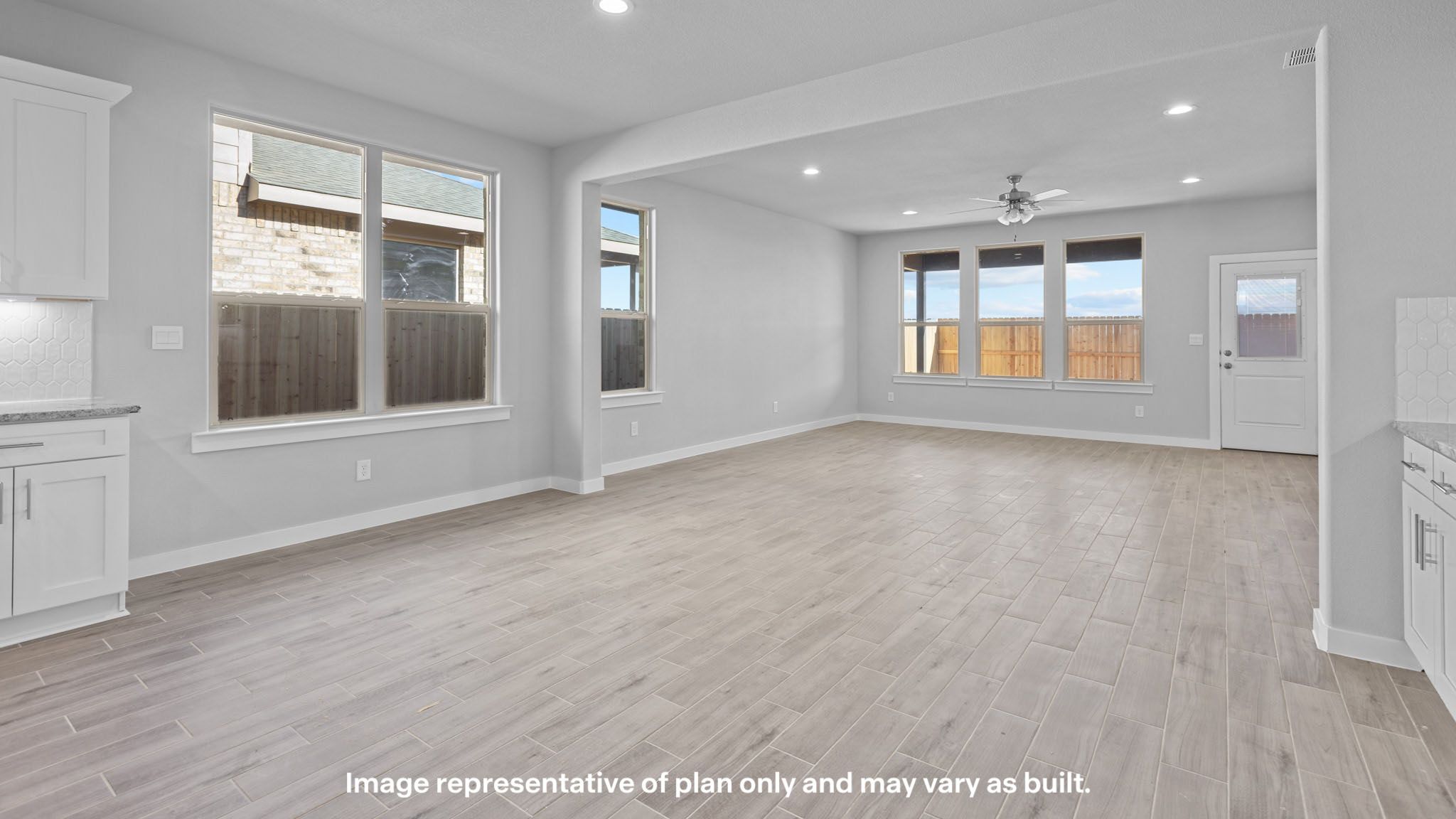 Spacious living and family room space with light allowing windows