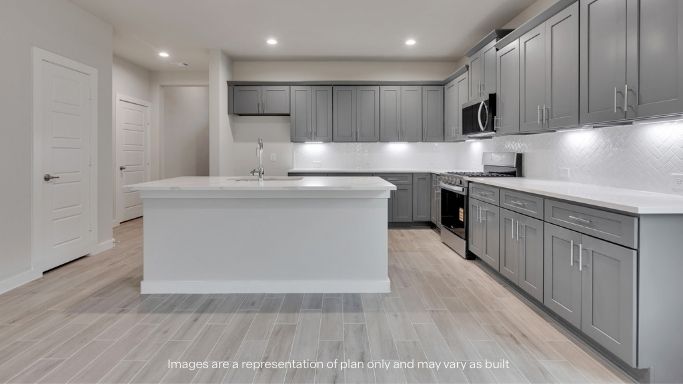 Open concept kitchen with stainless steel appliances, shaker style cabinets, and elevated finishes