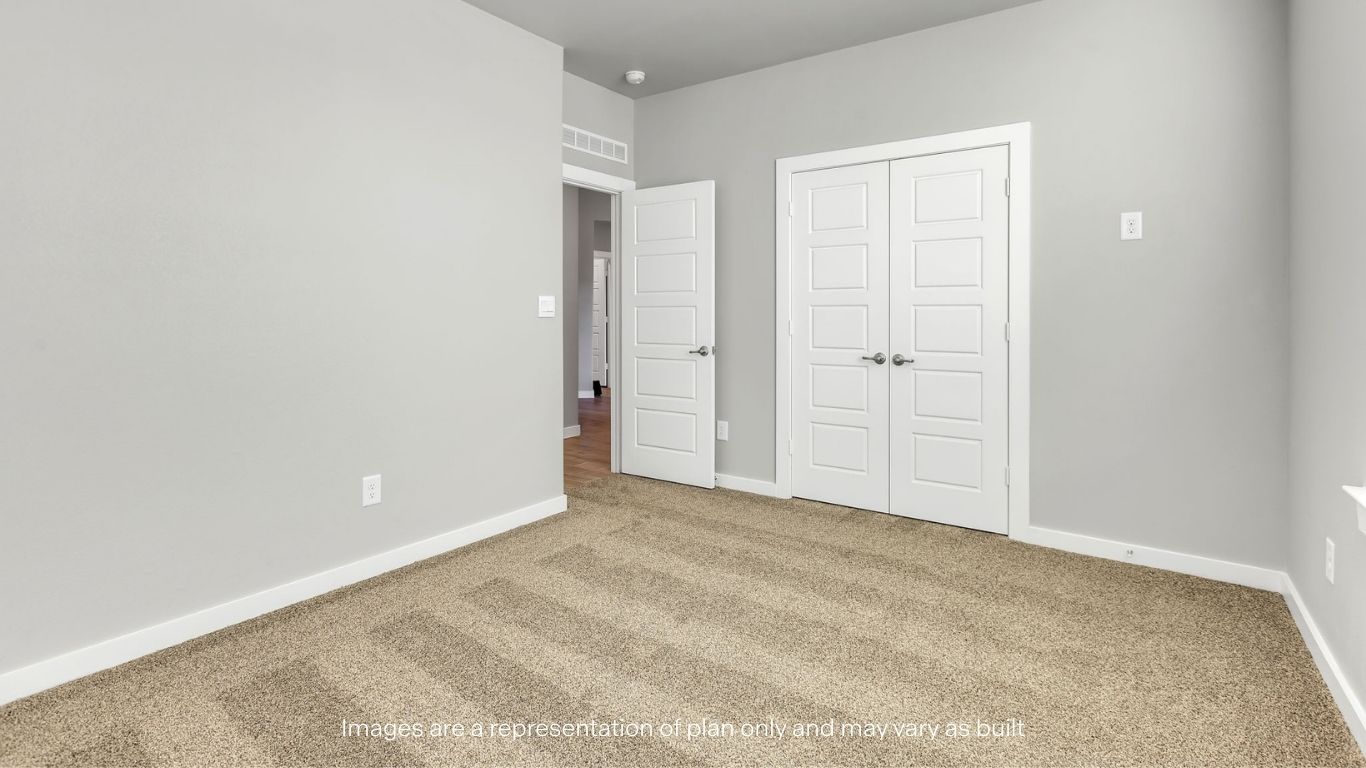 Guest bedroom 3 with plush carpet floors and spacious closet