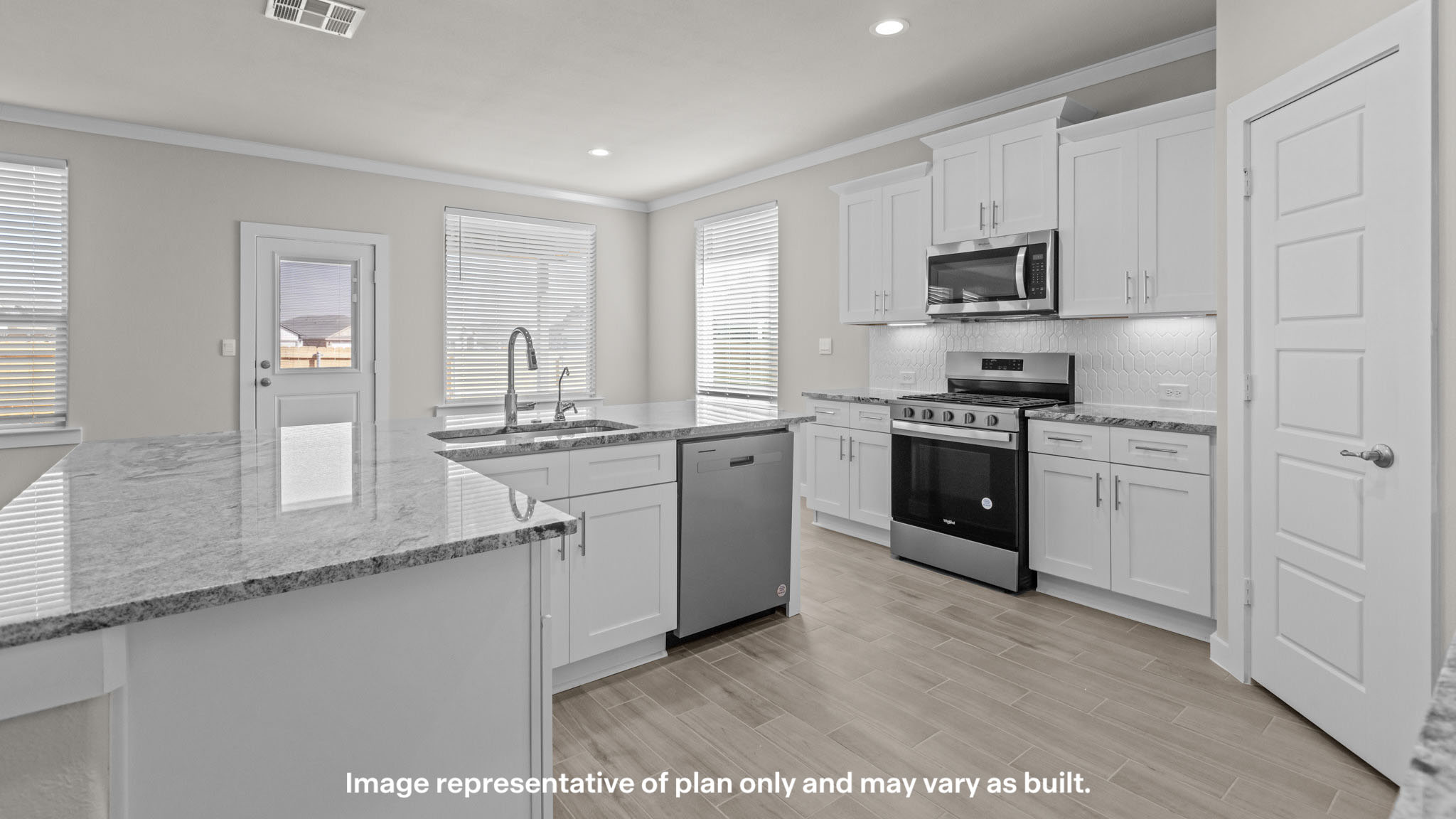 Kitchen with stainless steel appliances, shaker style cabinets, and elevated finishes