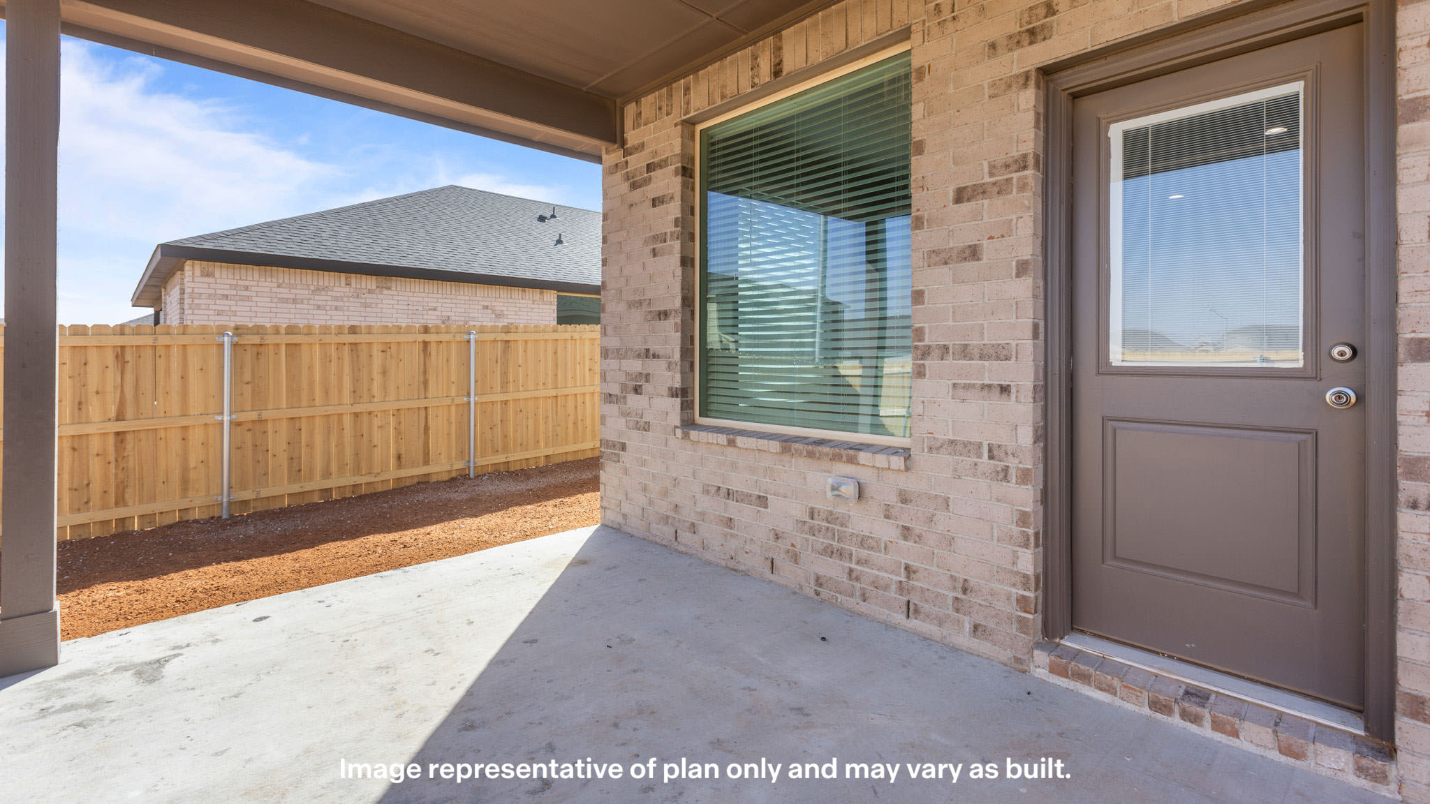 Covered back patio area overlooking spacious backyard