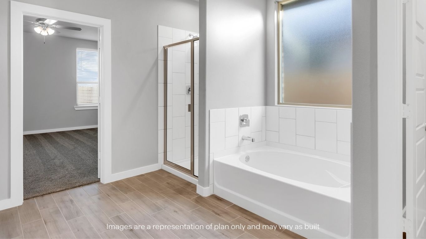 Primary bathroom with tiled shower and separate bathtub