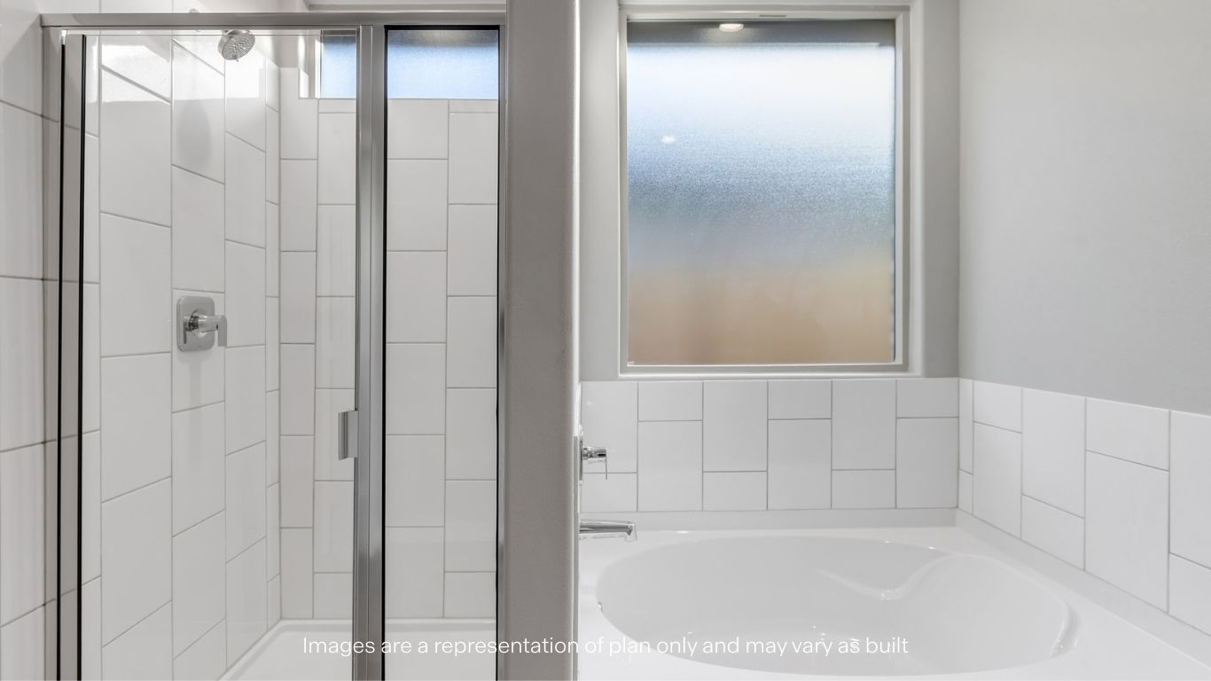 Primary bathroom with tiled shower and separate bathtub