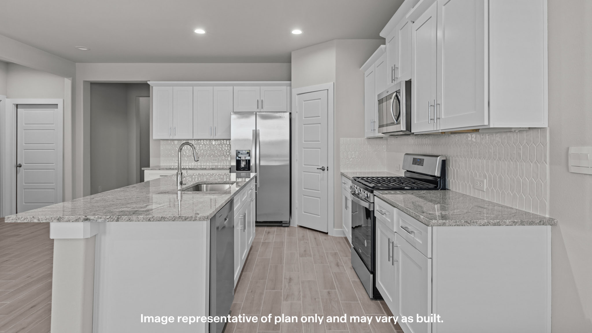 Kitchen with stainless steel appliances, shaker style cabinets, and elevated finishes