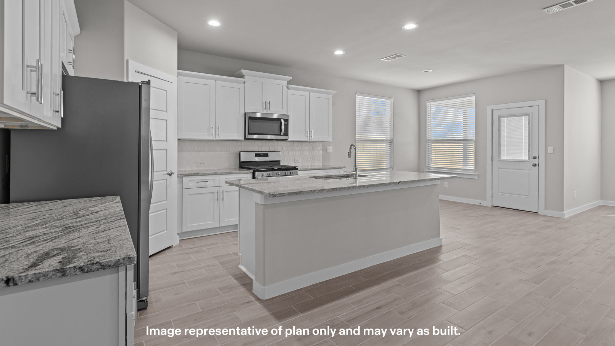 Spacious open concept kitchen with island and counter prep space