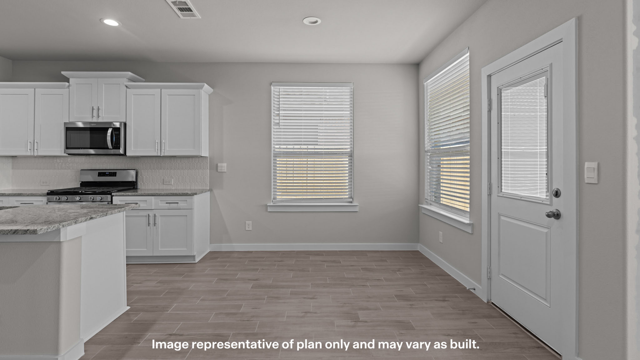 Cozy dining nook space to the side of the kitchen overlooking backyard