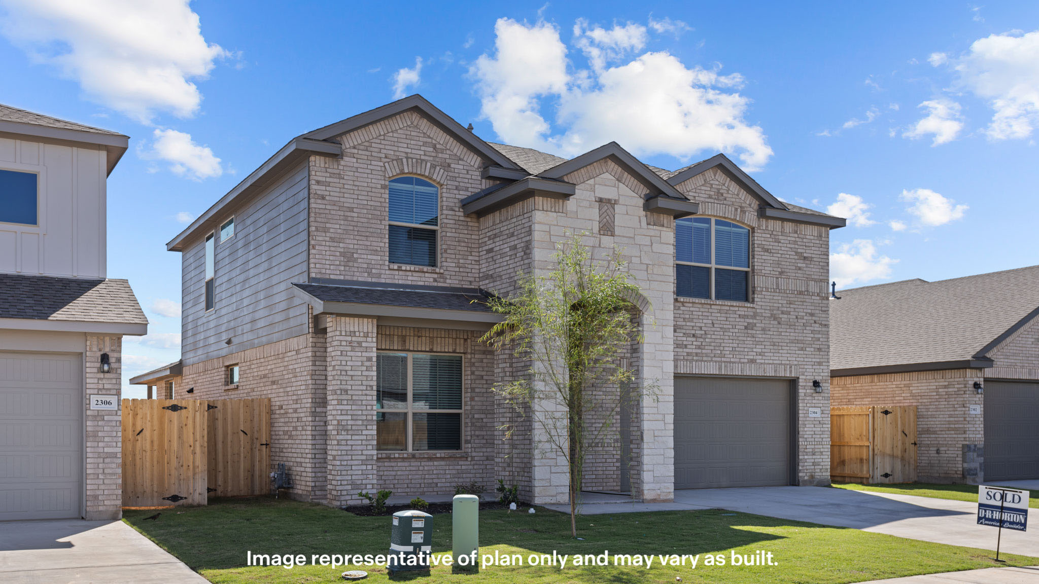 Side view of two story timeless brick home