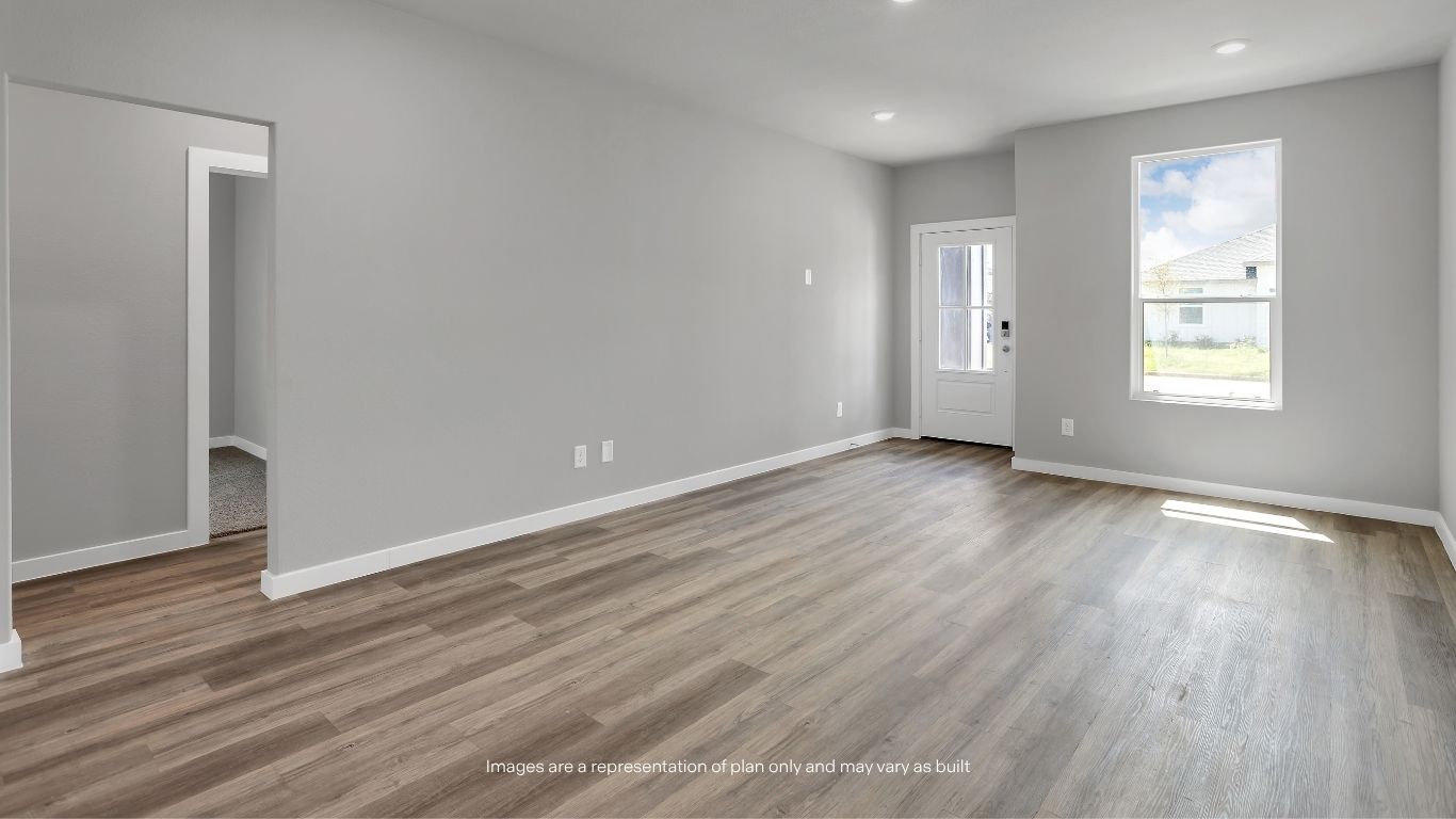 The spacious family room offers an open layout with abundant natural light, providing the perfect space for relaxing and entertaining.
