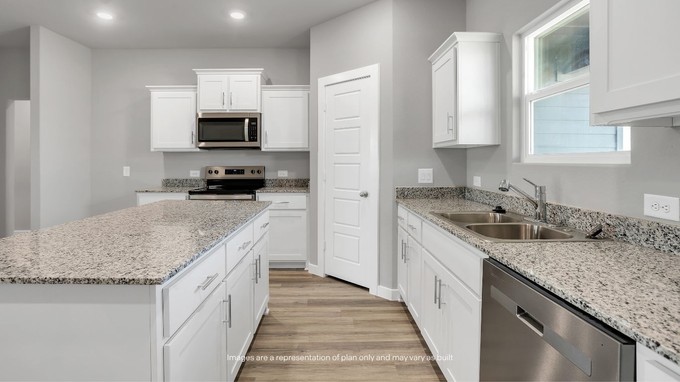 The oversized island provides additional seating and workspace, making meal preparation and entertaining effortless.