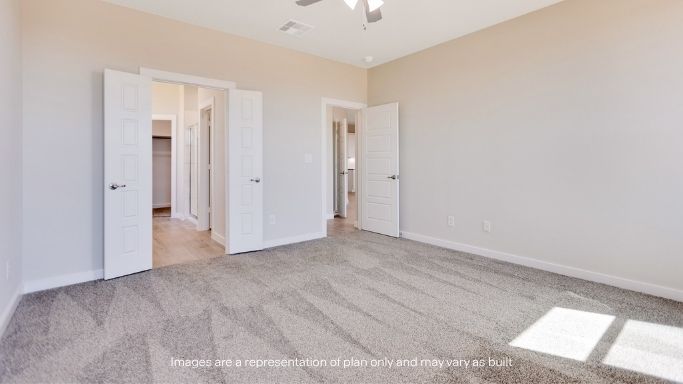 Primary bedroom with plush carpet floors and light allowing double windows