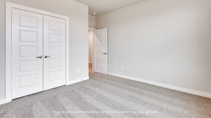Guest bedroom 4 with plush carpet and side window