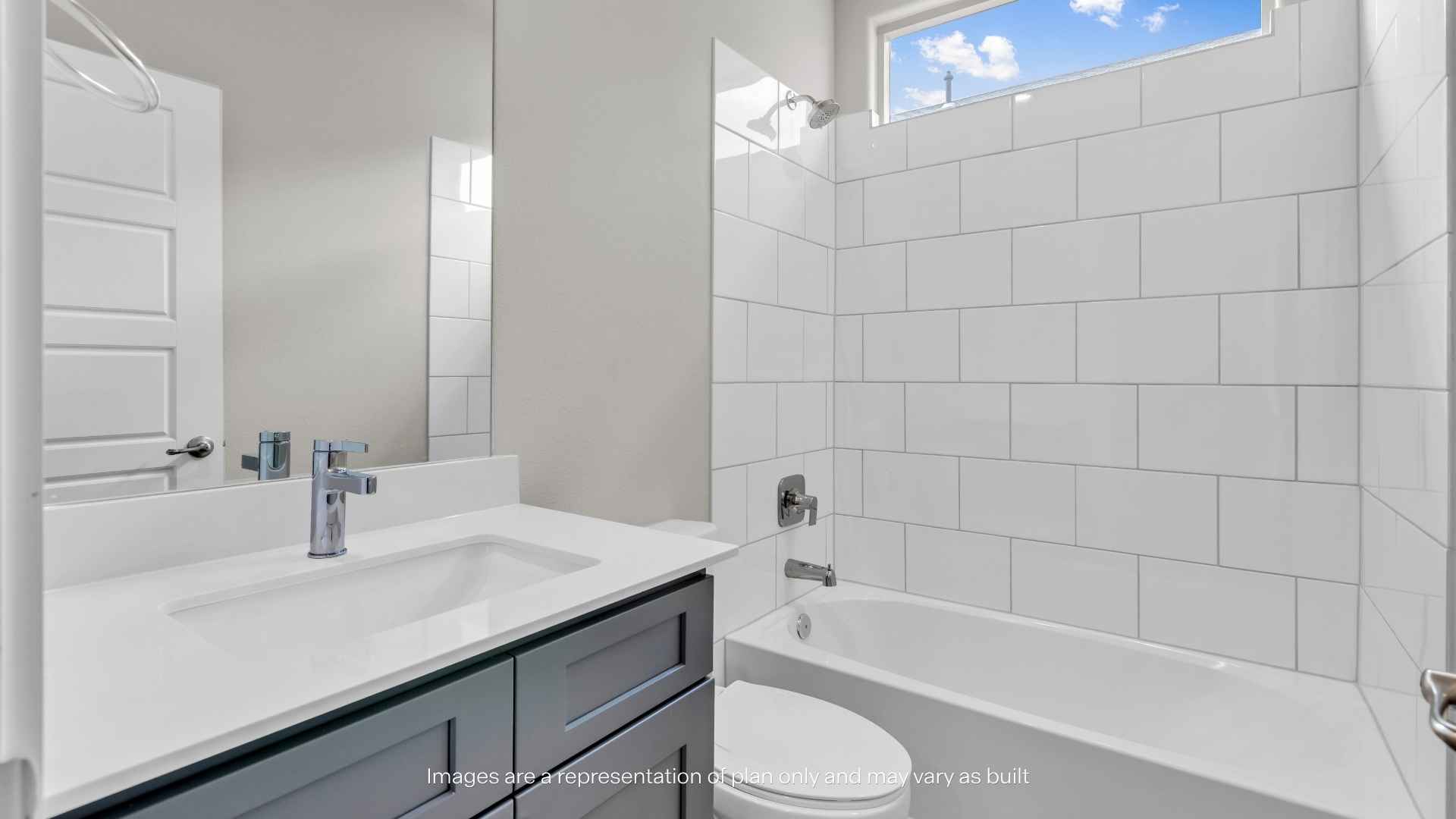 Full bathroom with single-sink vanity, bathtub, and white tile surround.