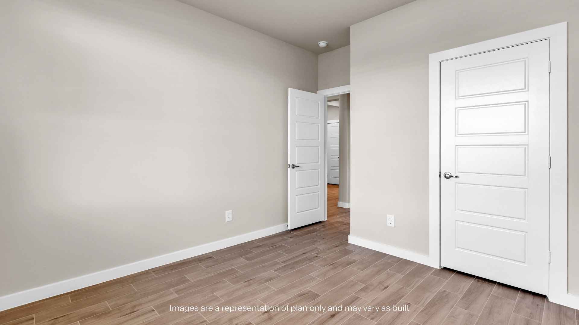 front room with light gray walls, wood-look tile flooring, and a large window with white blinds allowing natural light into the space.