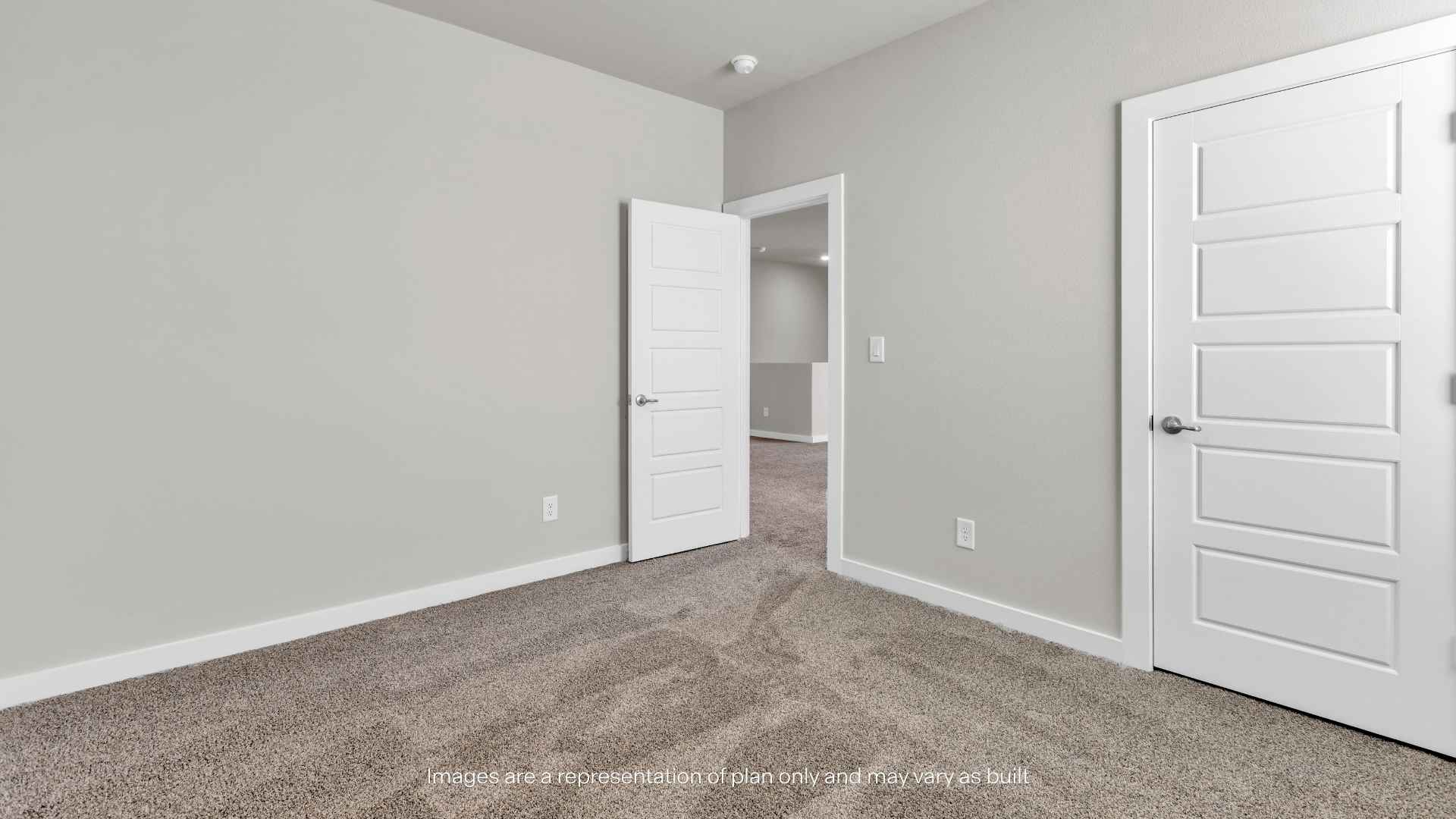 Bedroom with carpet flooring, neutral walls, and closet access.