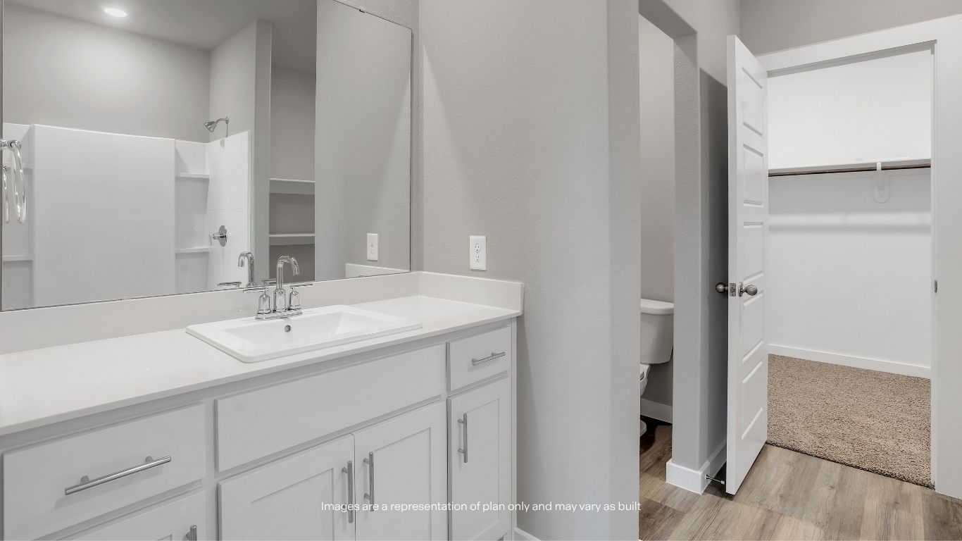 Designed for comfort and privacy, the primary bedroom provides direct access to the ensuite bathroom and walk-in closet.
