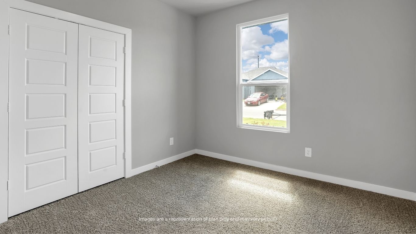 This versatile bedroom features plush carpeting and natural light, making it ideal for family members, guests, or a home office.
